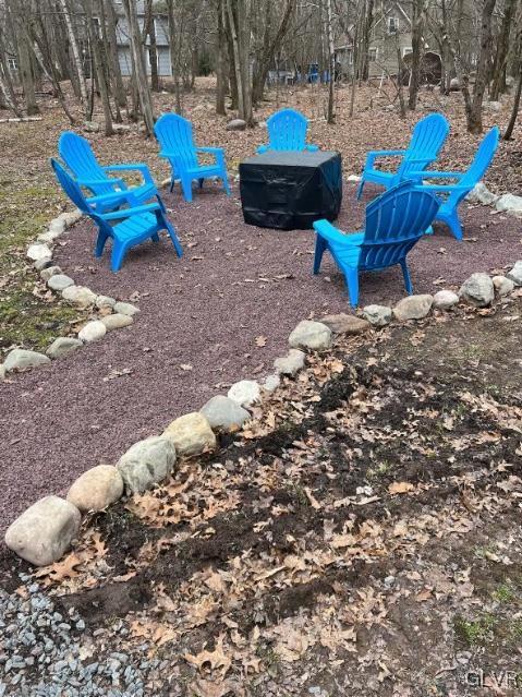 view of yard with an outdoor fire pit