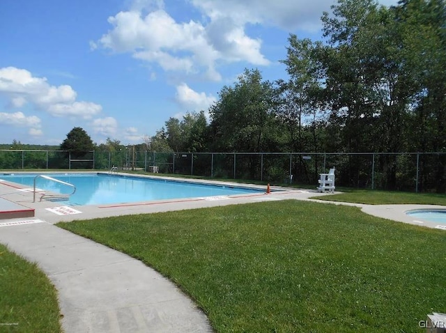 pool with a lawn and fence