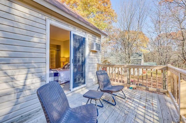 wooden deck featuring an AC wall unit