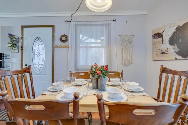 dining room with crown molding and hardwood / wood-style floors