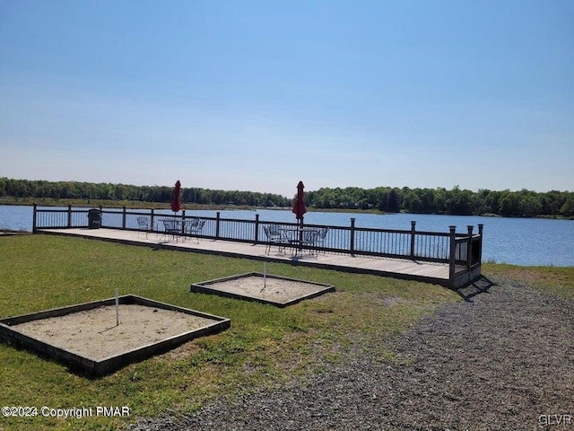 dock area featuring a water view and a yard