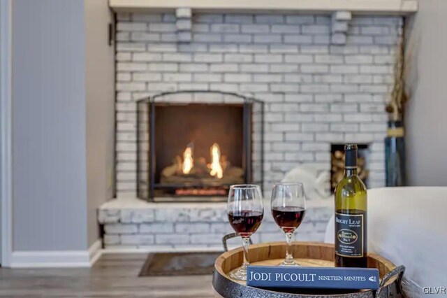 details with a fireplace and hardwood / wood-style flooring