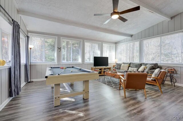 interior space featuring a textured ceiling, pool table, hardwood / wood-style flooring, ceiling fan, and vaulted ceiling with beams