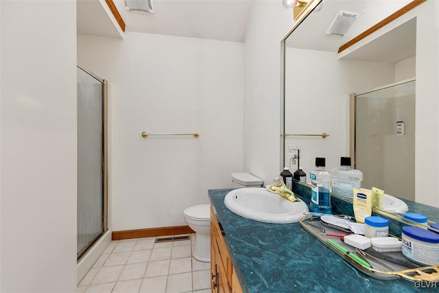 bathroom with tile patterned floors, toilet, a shower with door, and vanity