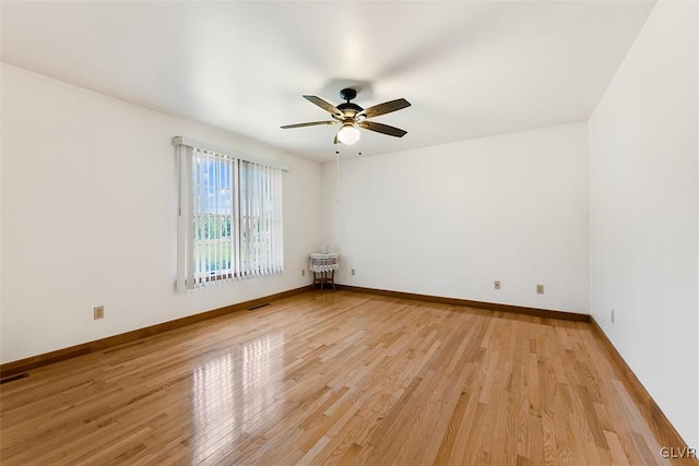 spare room featuring light hardwood / wood-style flooring and ceiling fan