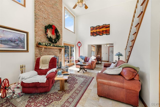 living room with ceiling fan and a towering ceiling