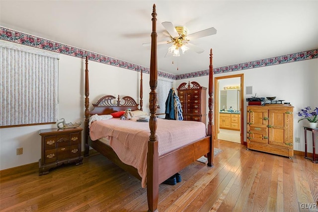 bedroom featuring ceiling fan, wood-type flooring, and ensuite bath