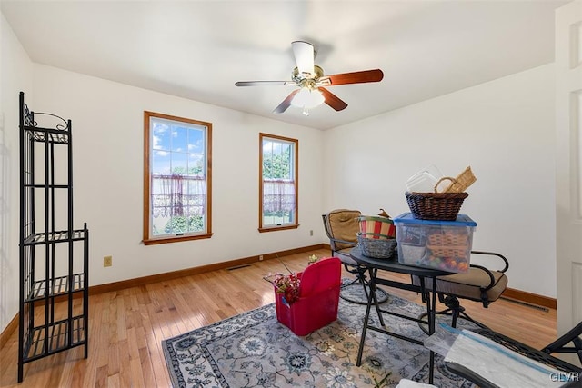 home office featuring ceiling fan and wood-type flooring