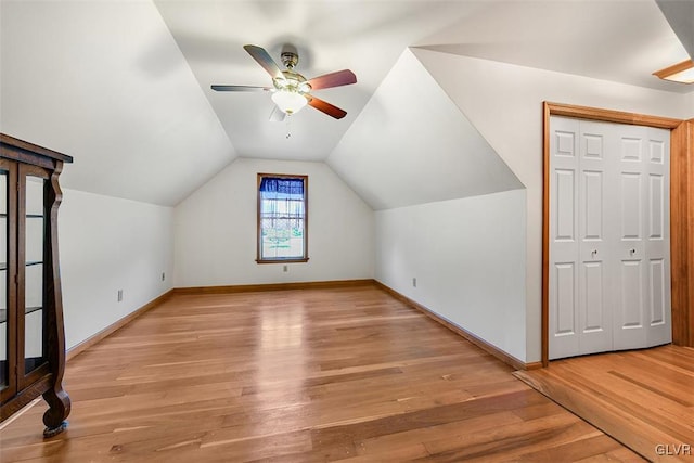 bonus room with light wood-type flooring, lofted ceiling, and ceiling fan