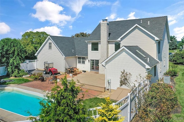 back of house with a fire pit, central AC, and a patio