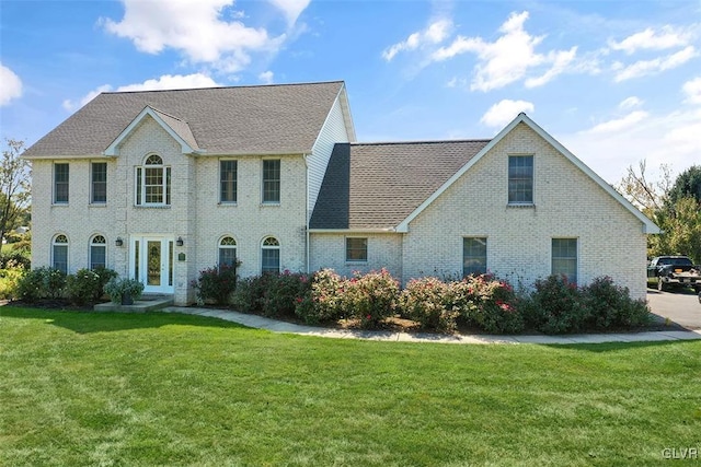 colonial-style house with a front yard