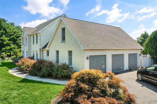 view of front of property featuring a garage and a front yard