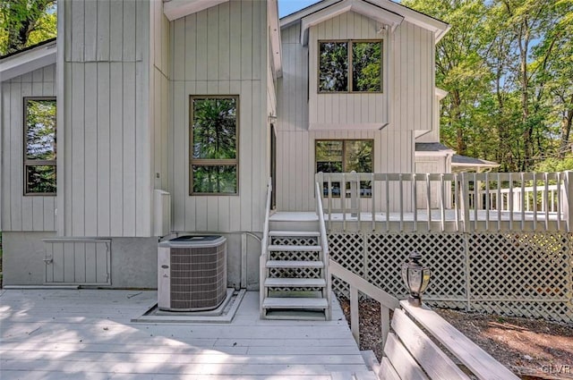 rear view of property featuring central air condition unit and a deck