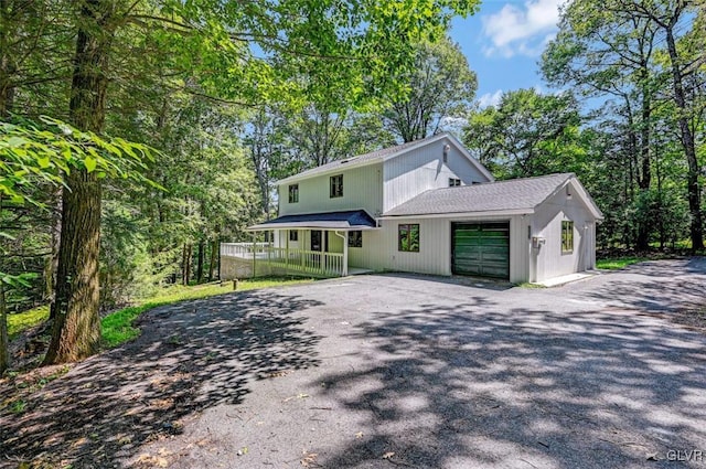 view of front of house with a garage and a porch