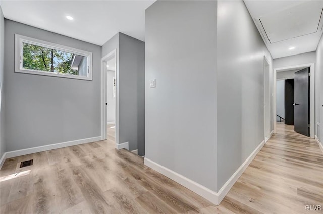 hallway with light hardwood / wood-style floors