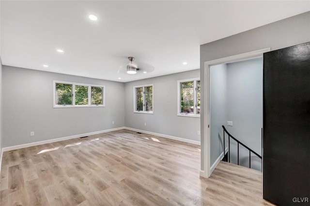 spare room featuring light wood-type flooring and ceiling fan