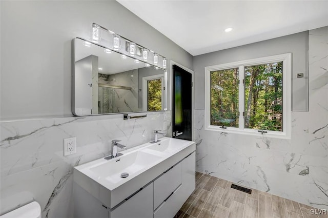 bathroom featuring toilet, a shower with door, wood-type flooring, and vanity