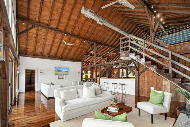 unfurnished living room featuring wooden ceiling, wood-type flooring, beam ceiling, and ceiling fan