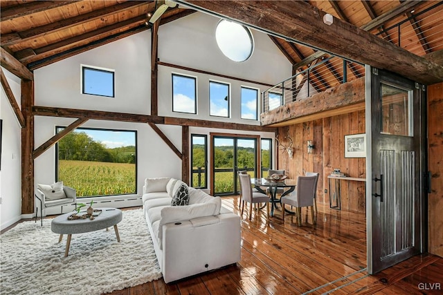 living room with wood walls, high vaulted ceiling, dark hardwood / wood-style floors, and beamed ceiling