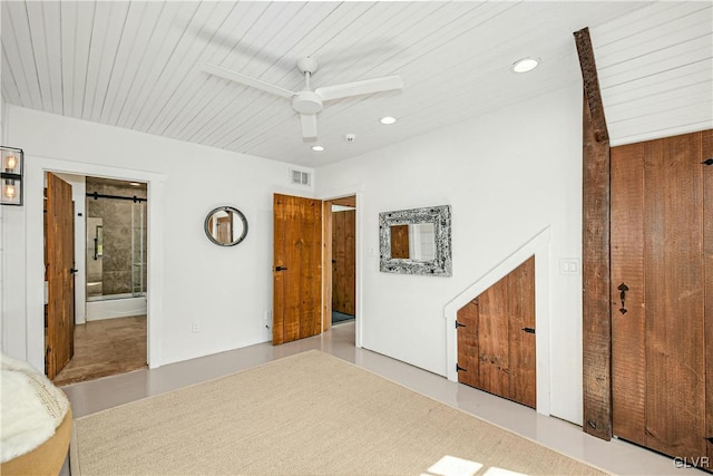 unfurnished bedroom with wood ceiling, ensuite bathroom, ceiling fan, and a closet