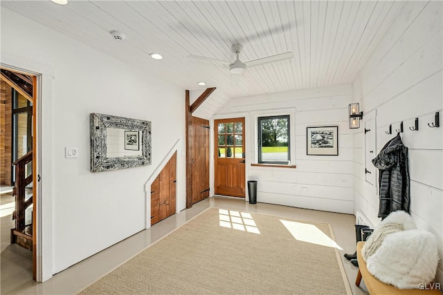 interior space featuring wood ceiling and wood walls