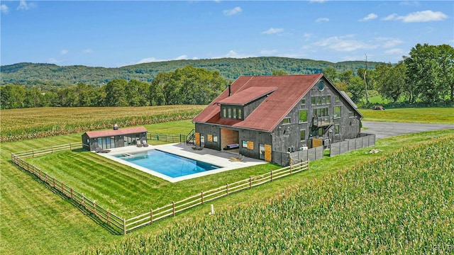 view of pool featuring a yard and a rural view