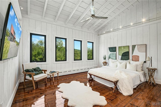 bedroom with wooden walls, vaulted ceiling with beams, ceiling fan, and dark hardwood / wood-style floors