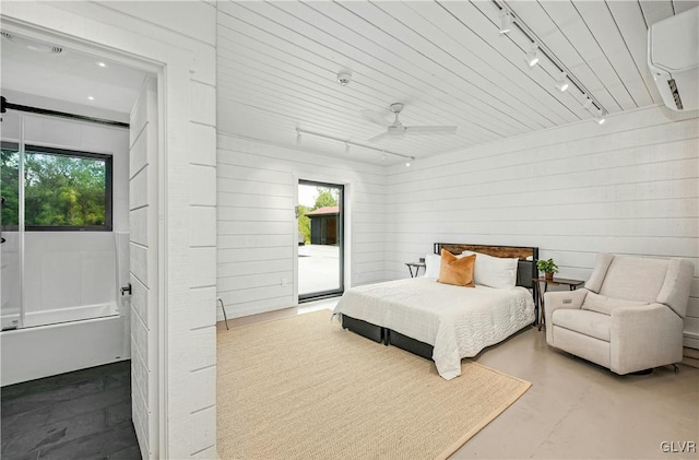 bedroom featuring multiple windows, concrete floors, access to exterior, and ceiling fan