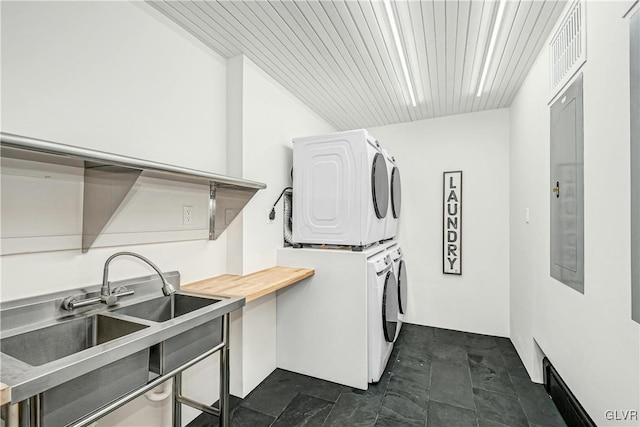 washroom with wood ceiling, electric panel, sink, and stacked washer / drying machine