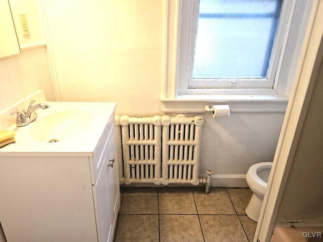 bathroom featuring radiator, tile patterned flooring, vanity, and toilet