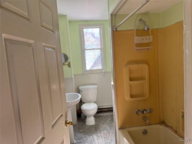 bathroom featuring toilet and  shower combination