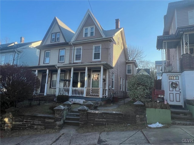 victorian-style house featuring covered porch