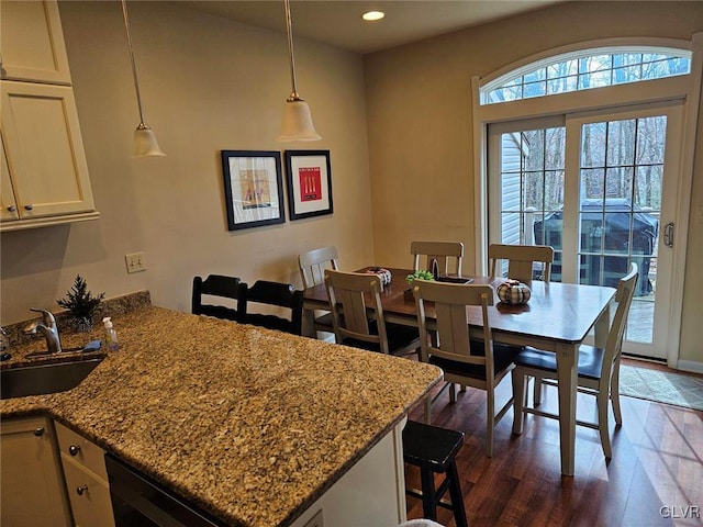 dining room with dark hardwood / wood-style flooring and sink