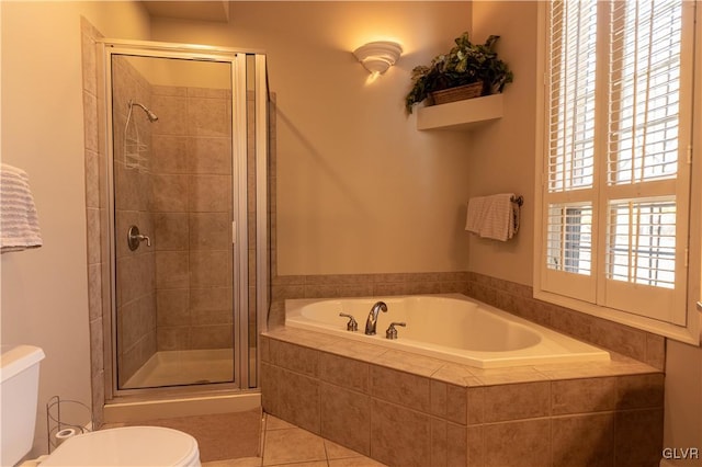 bathroom with separate shower and tub, tile patterned floors, and toilet