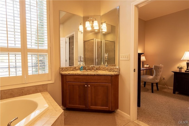 bathroom with tile patterned flooring, independent shower and bath, and vanity