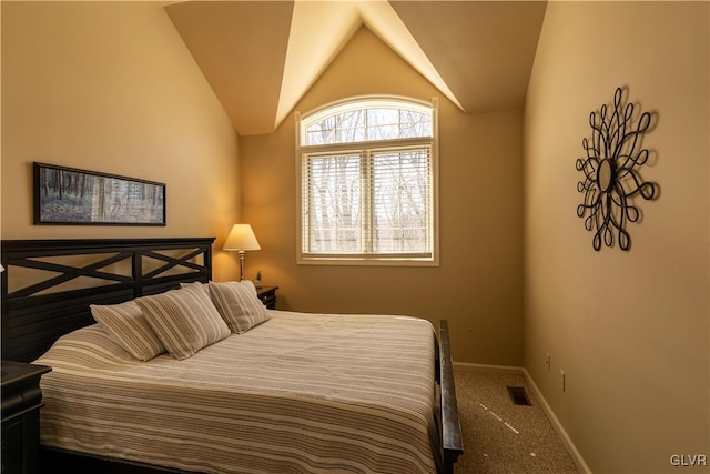 carpeted bedroom featuring lofted ceiling