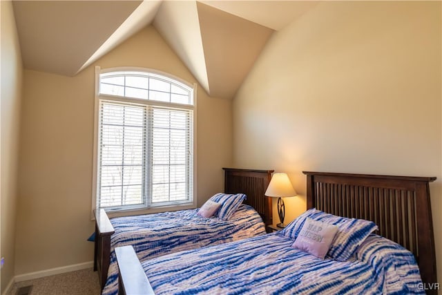 bedroom with carpet floors, lofted ceiling, and multiple windows