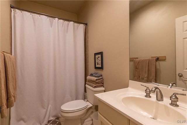 bathroom featuring walk in shower, vanity, and toilet