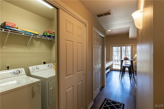 laundry room featuring separate washer and dryer and dark wood-type flooring