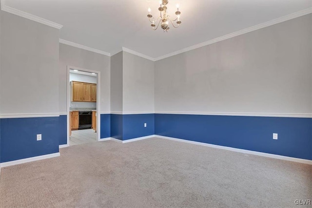 carpeted spare room with a chandelier and ornamental molding