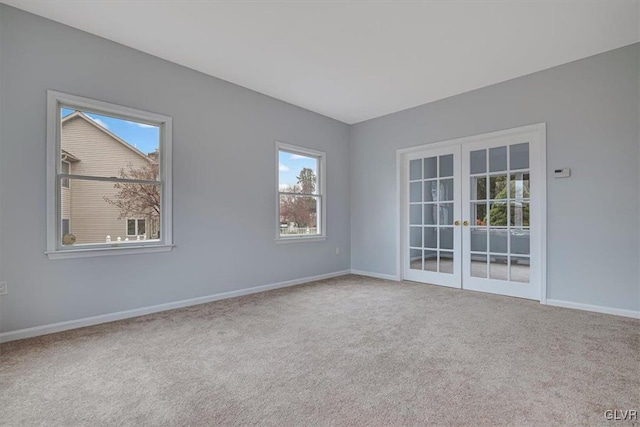 spare room featuring french doors and carpet floors