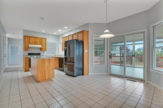 kitchen featuring range, light tile patterned floors, stainless steel fridge with ice dispenser, a kitchen island, and hanging light fixtures