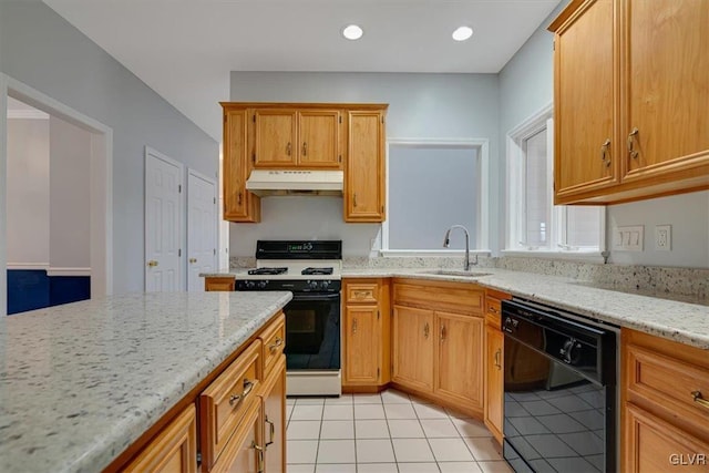 kitchen featuring dishwasher, sink, light tile patterned floors, gas range gas stove, and light stone counters