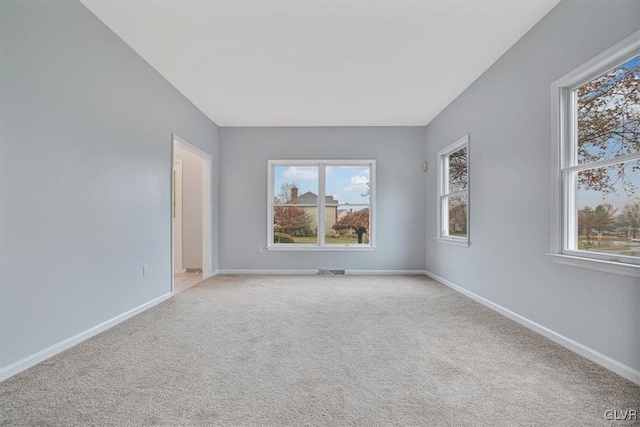 unfurnished room with light carpet