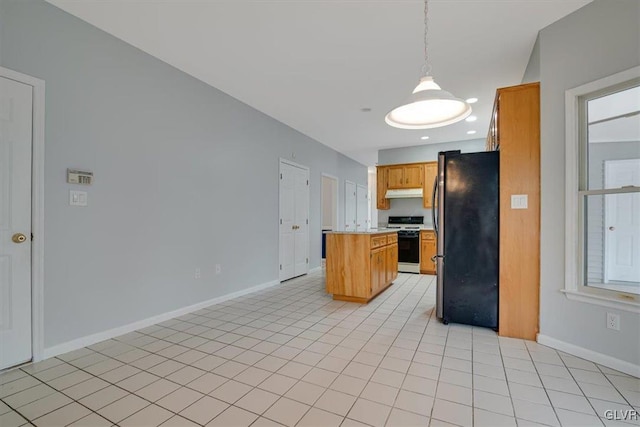 kitchen featuring pendant lighting, white range oven, light tile patterned floors, and stainless steel refrigerator