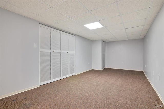 basement with carpet flooring and a drop ceiling