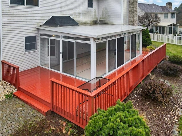 wooden deck featuring a sunroom