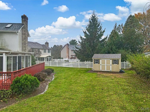 view of yard with a sunroom and a shed