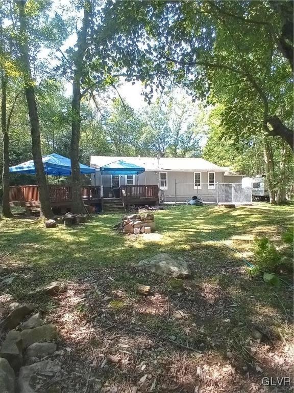 view of yard featuring a wooden deck