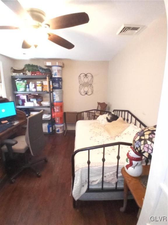 bedroom with dark hardwood / wood-style floors and ceiling fan